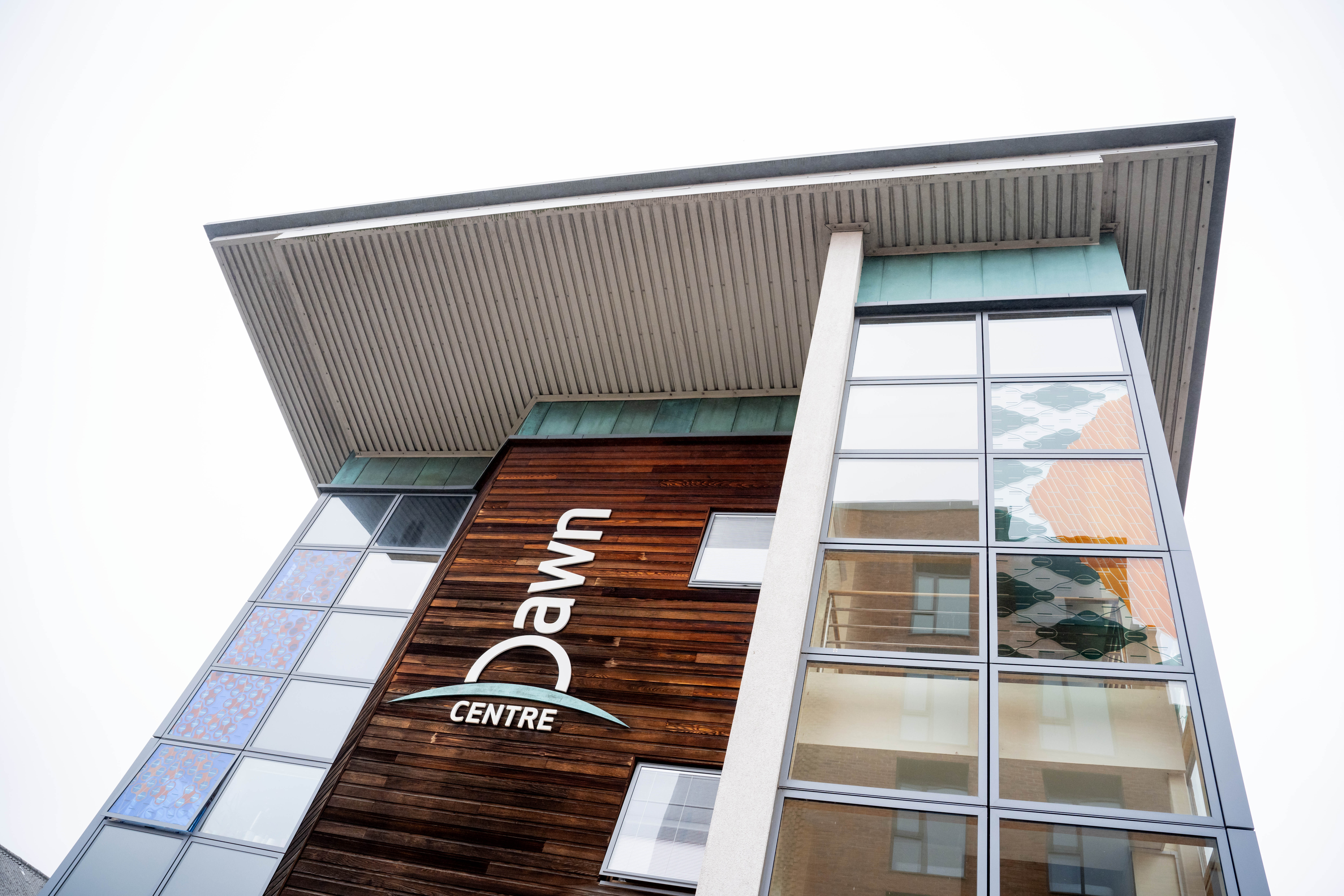 A tall modern building with a sign saying Dawn Centre.