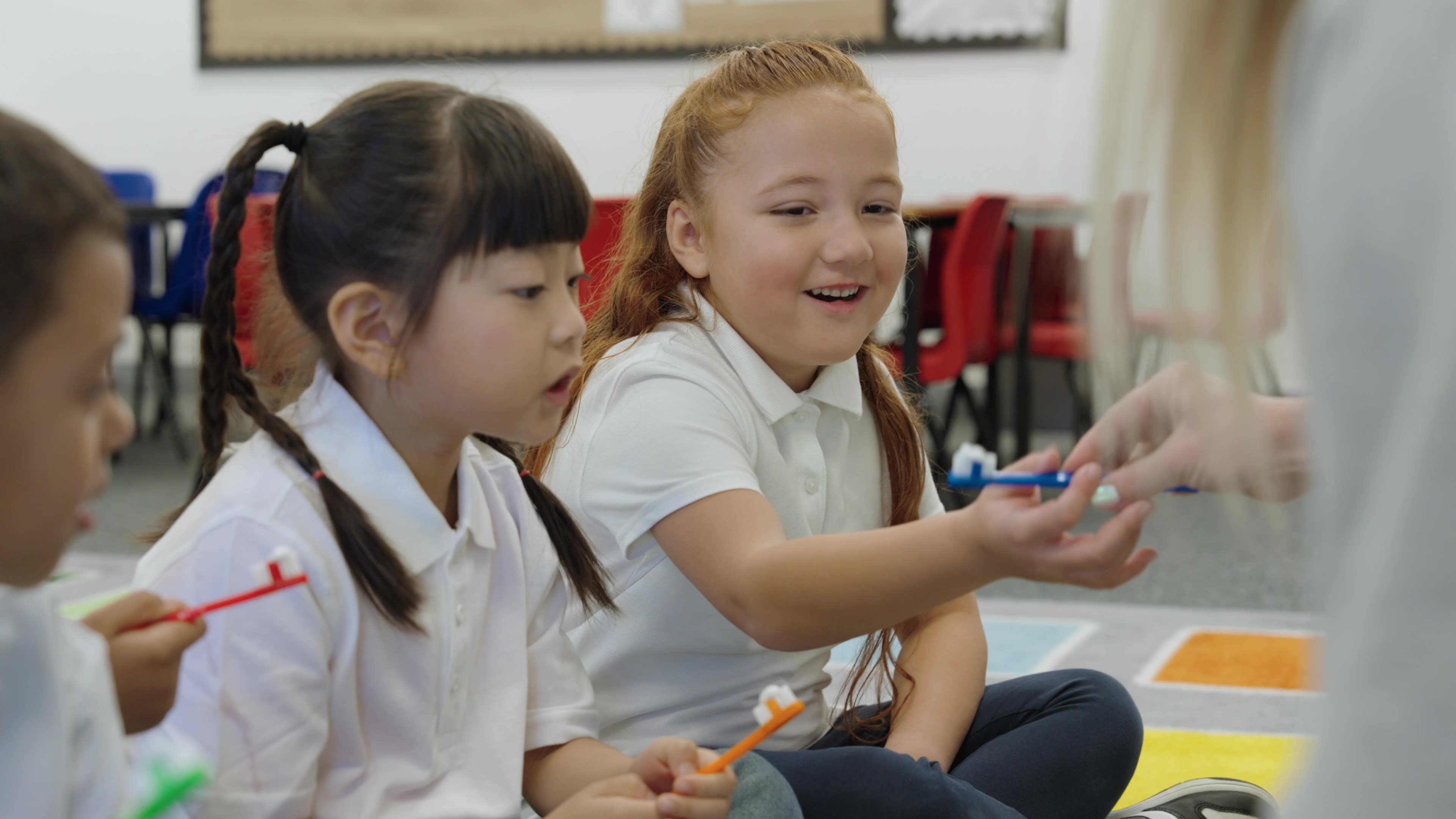 Children brushing their teeth in a classroom setting