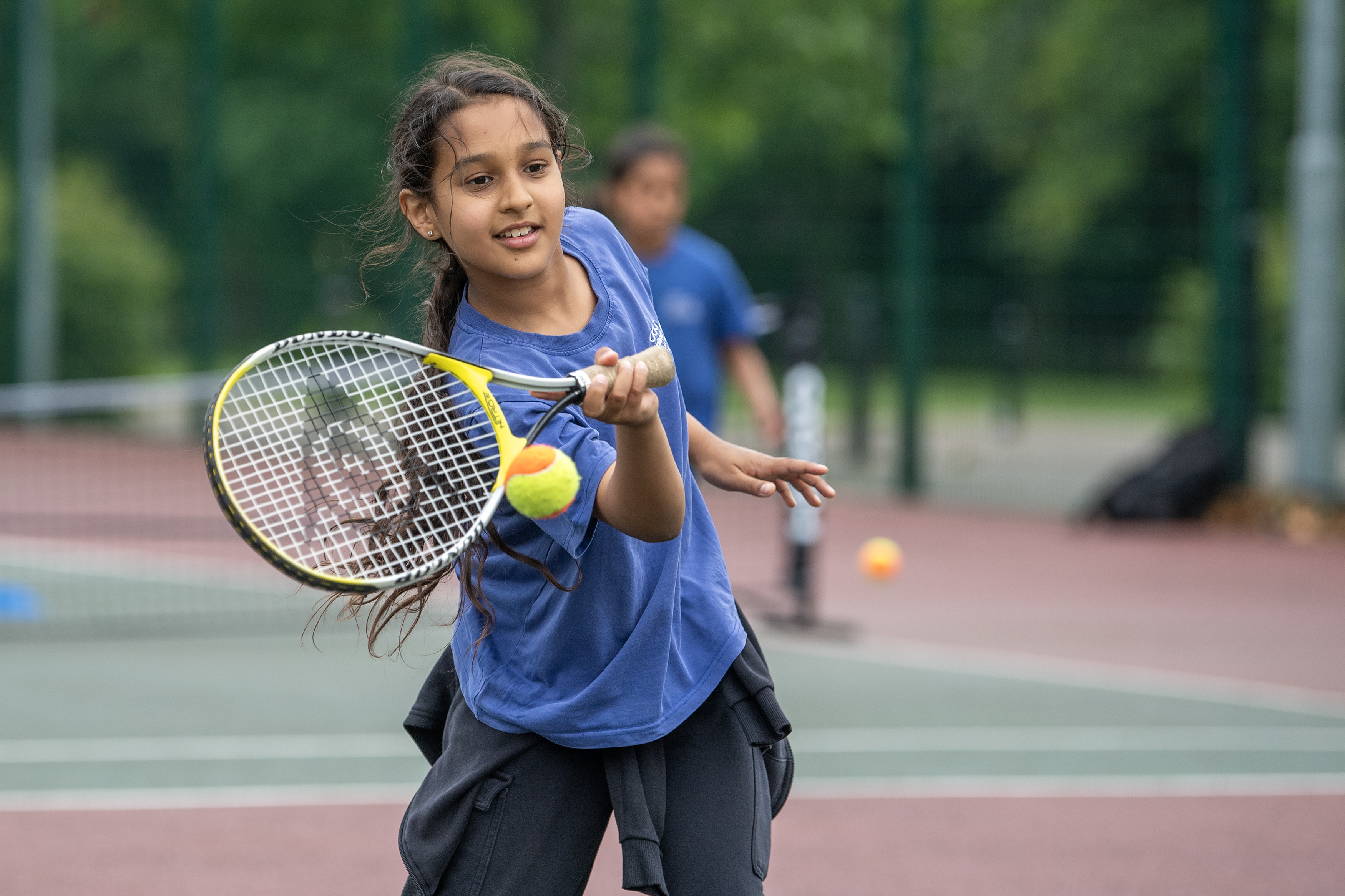 A pupil from Uplands Junior School playing tennis