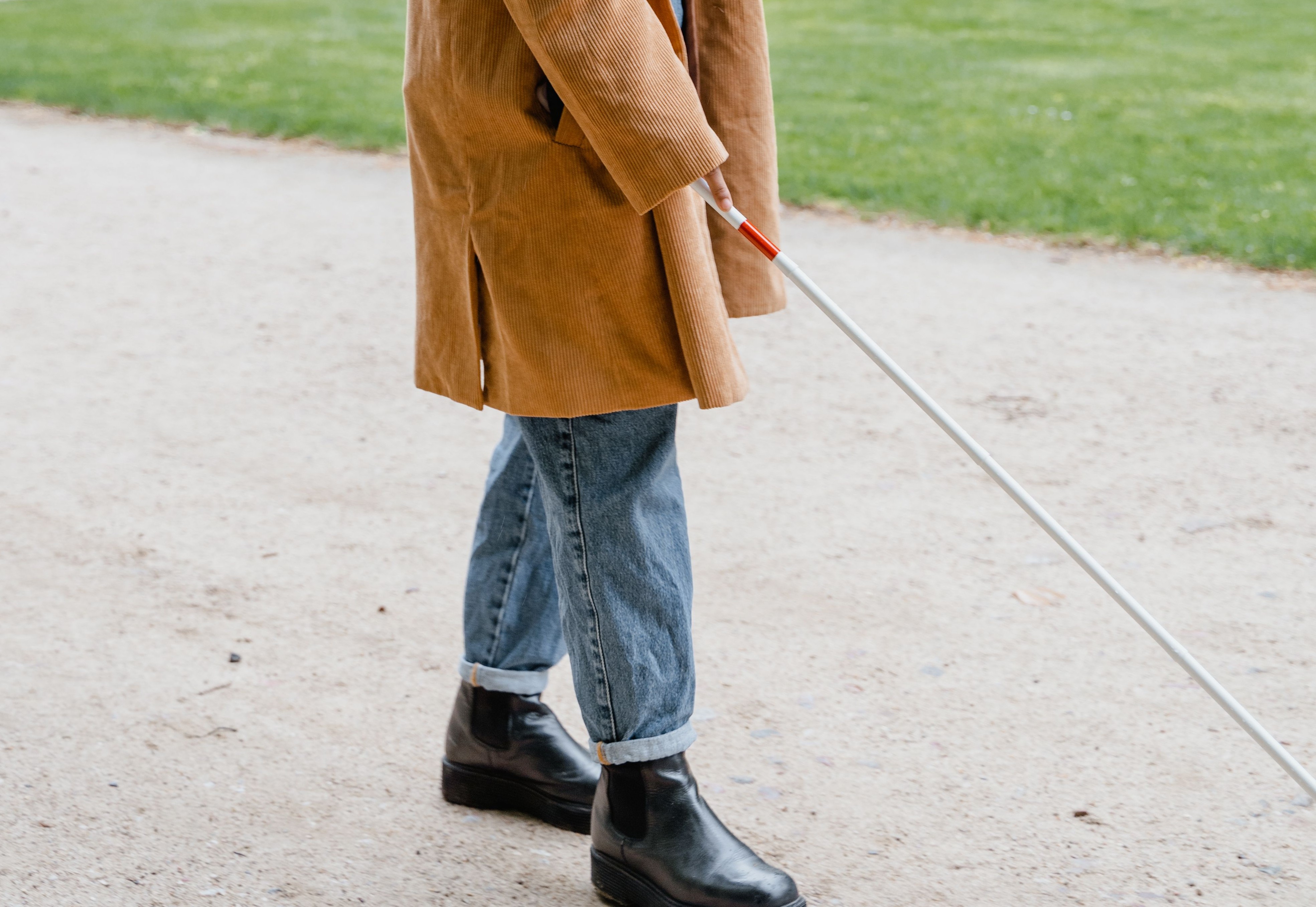 a person holds a white cane