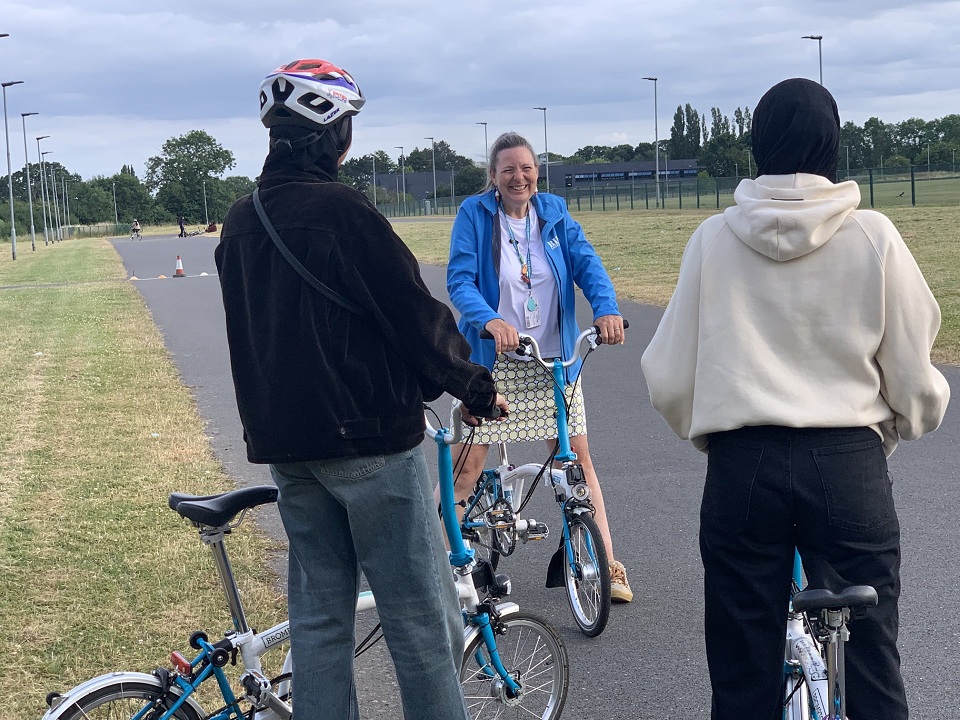A picture of a cycle trainer with a couple of adult pupils in Leicester