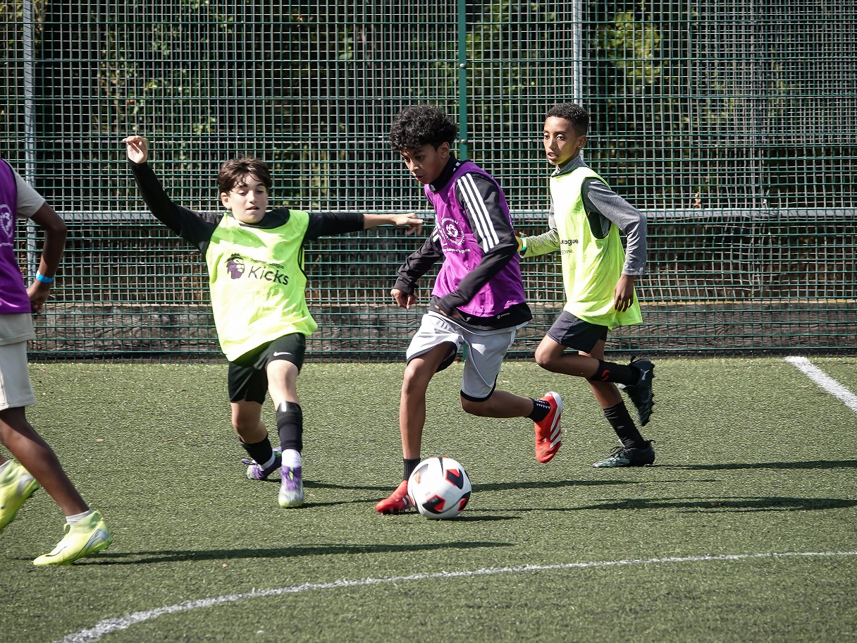 Kids playing football at the end of summer tournament in Leicester